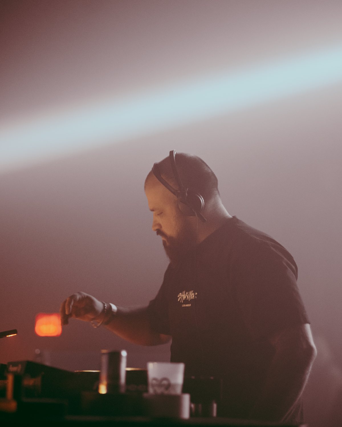 OldGold at the decks in headphones, in rose-colored haze
